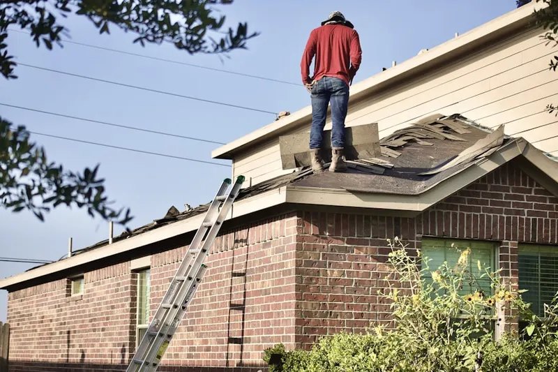 Professional roofer working on a residential roof in Stonebrook Farms